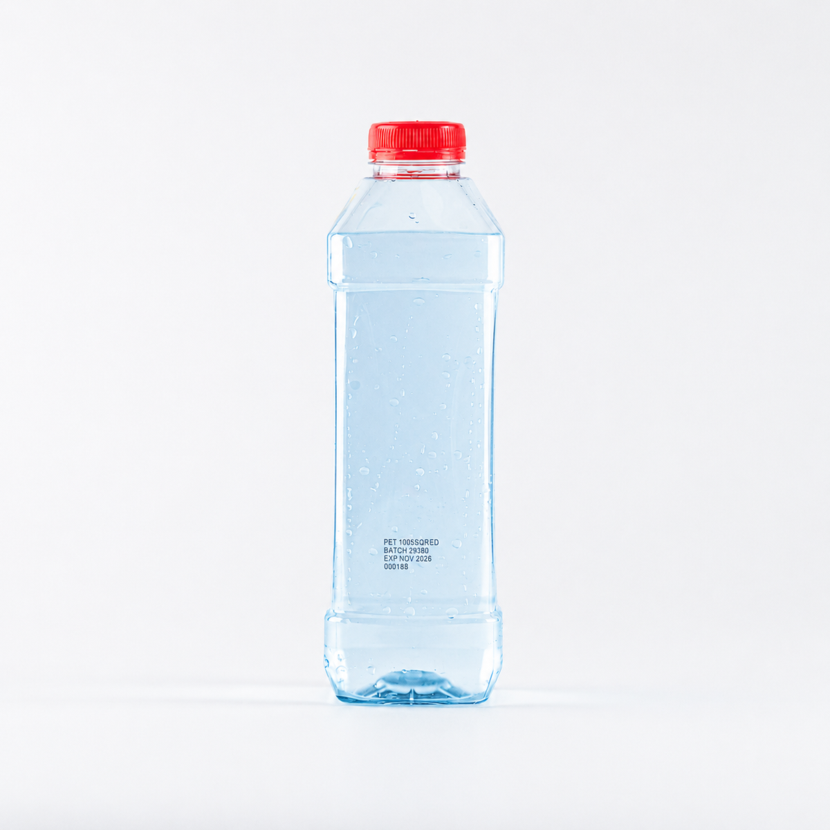 Clear water bottle with a red cap on a white background filled with light blue water