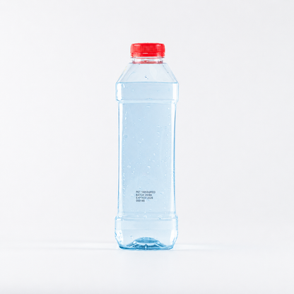 Clear water bottle with a red cap on a white background filled with light blue water