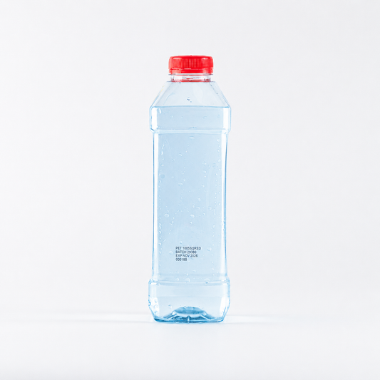 Clear water bottle with a red cap on a white background filled with light blue water