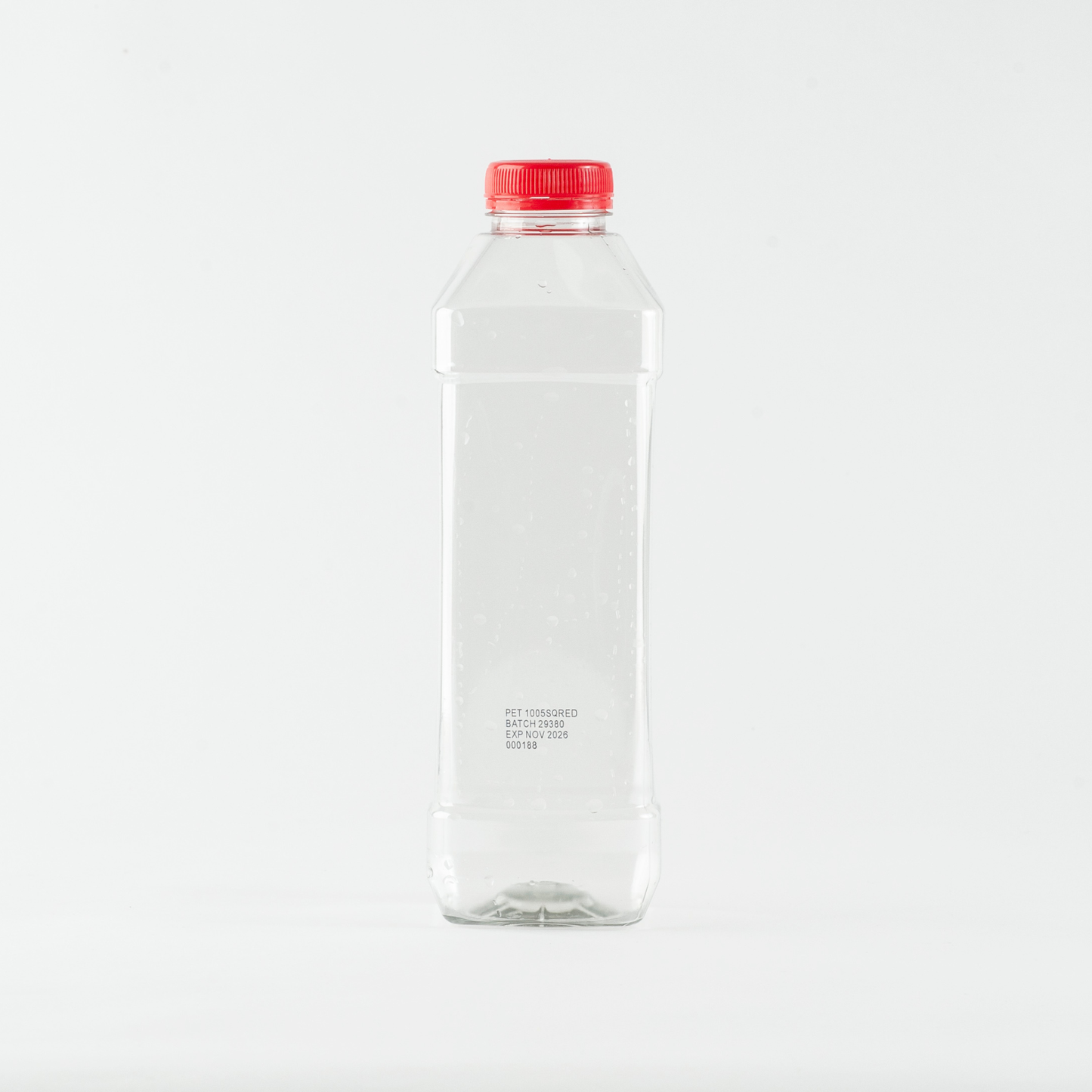 Clear plastic bottle with a red cap on a white background