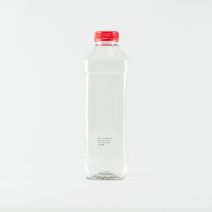 Clear plastic bottle with a red cap on a white background