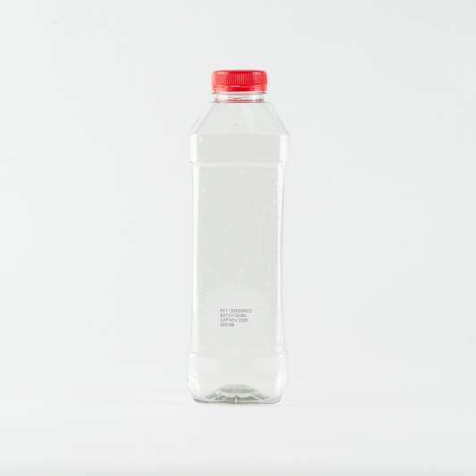 Clear plastic bottle with a red cap on a white background